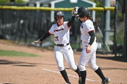 softball players give each other a high five